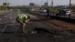 Kyiv bridge hit in further Russian drone attack as German chancellor makes surprise visit